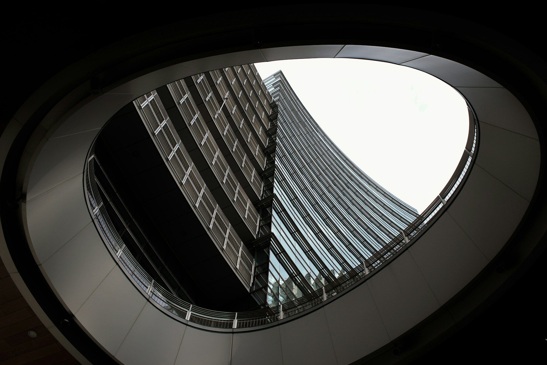 Photo by ANAÏS BAÏDA Modern architecture with curved balcony and glass building